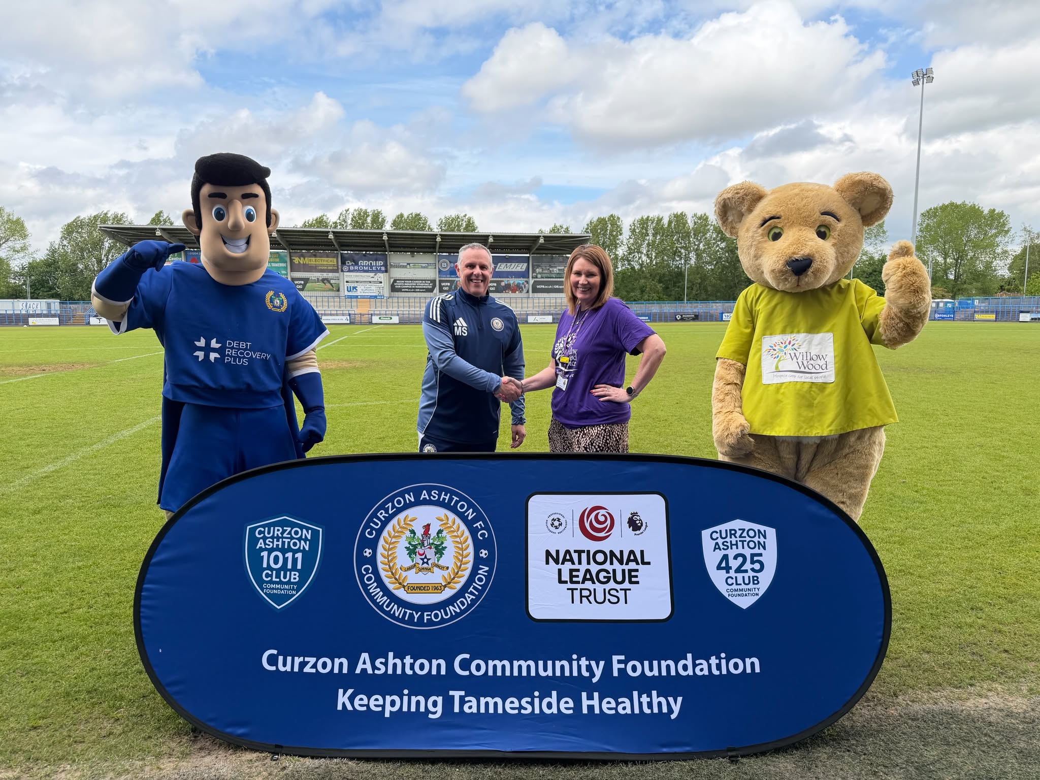Mike Smith from Curzon Ashton and Joanne Lees from Willow Wood Hospice with the football club and Hospice's mascots.