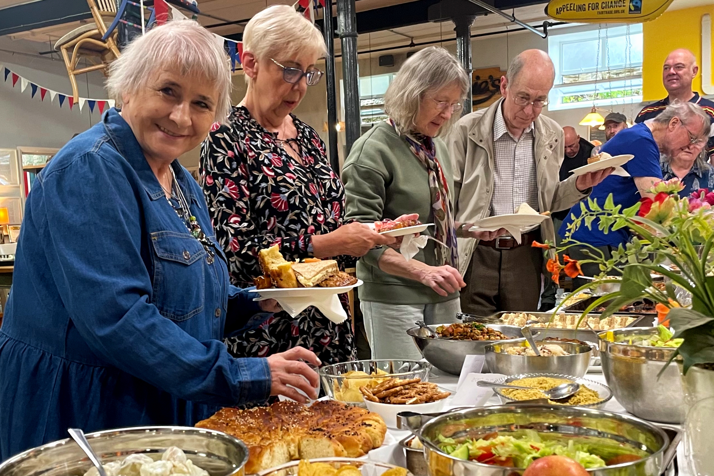 Guests enjoying food at Emmaus Mossley's Big Lunch event
