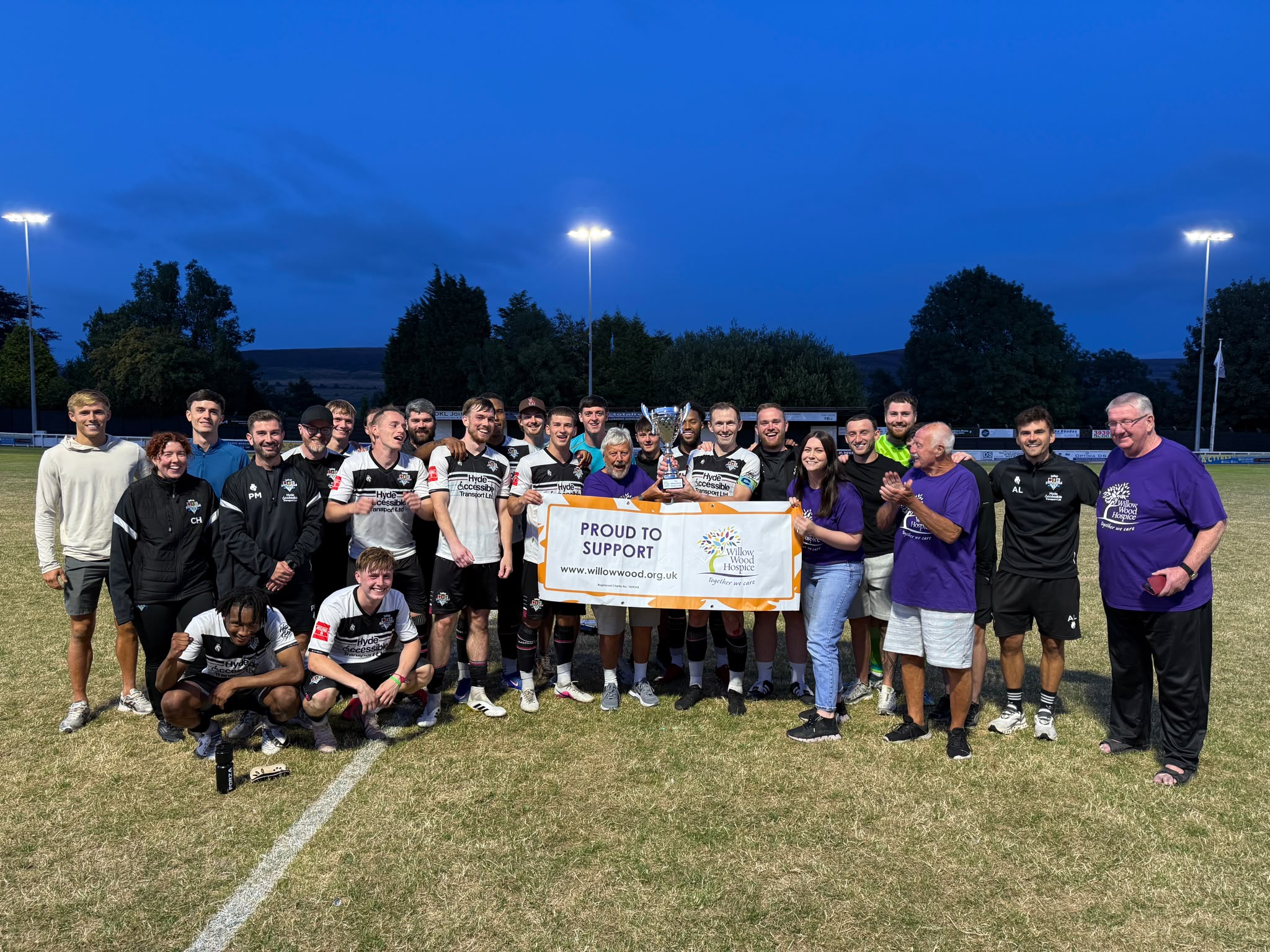 Mossley AFC and Hospice team celebrate with trophy. Photo credit: GGC Media.