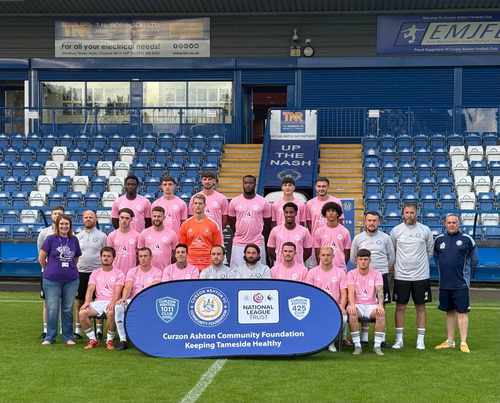 Joanne Lees from Willow Wood Hospice with the Curzon Ashton squad and Mike Smith from Curzon Ashton Community Foundation