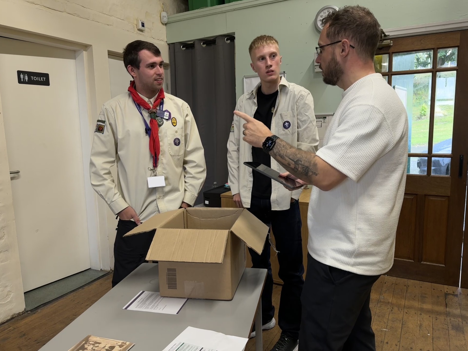 Scout leaders Robert and Lewis in conversation with a member of AO's team