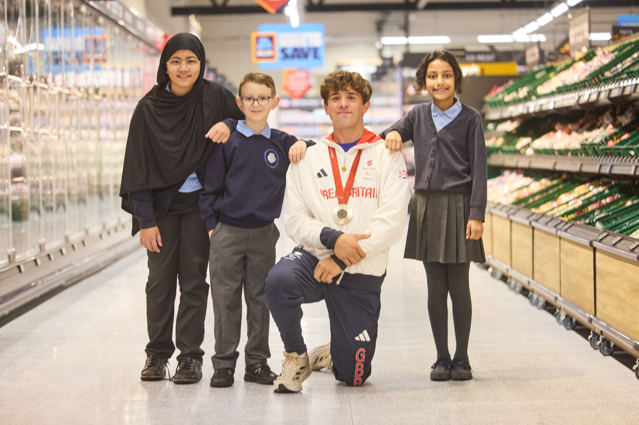 Archie with pupils from St James' Primary inside the new Aldi store